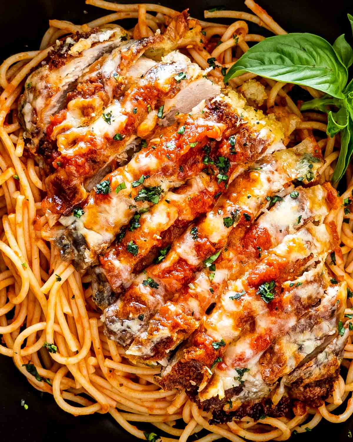 Spaghetti Chicken Parmesan with melted cheese and basil — a Pastaphony Fullerton signature