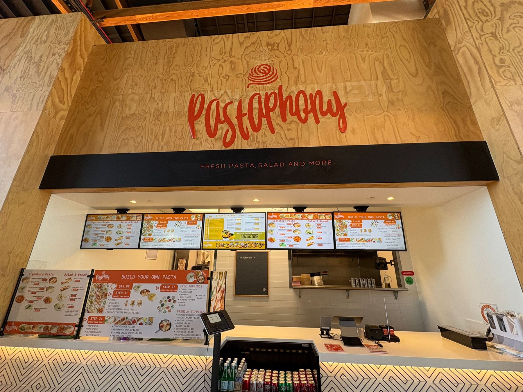 Pastaphony Tustin counter at FLIGHT Mess Hall with digital menus and the Pastaphony wordmark